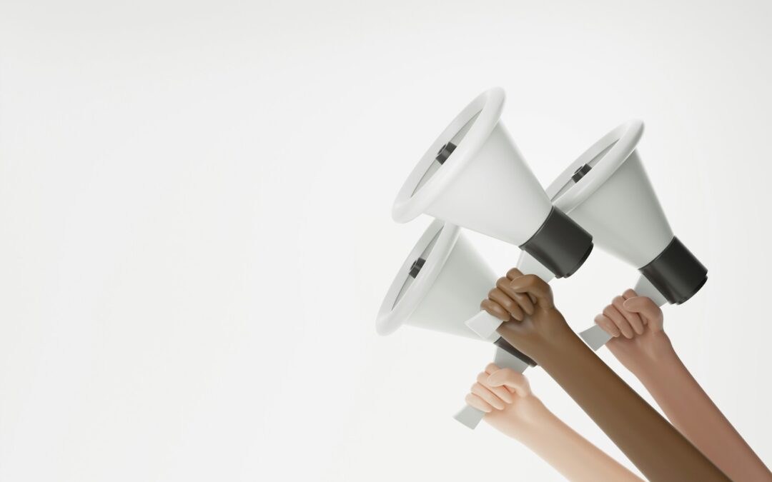 Multiple hands holding megaphones